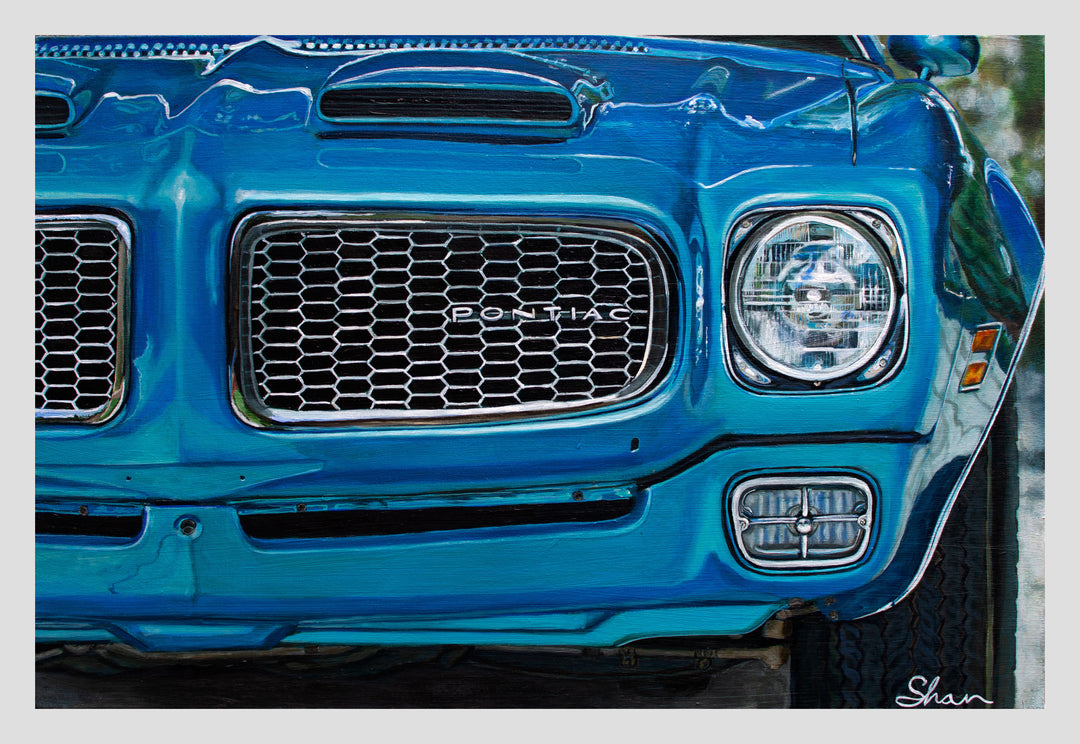 Close-up of the front grille and headlight of a blue 1972 Pontiac Firebird Formula 400 M22, with visible tire. Artwork by Shan Fannin, available as a 28 x 40" limited edition giclée print.