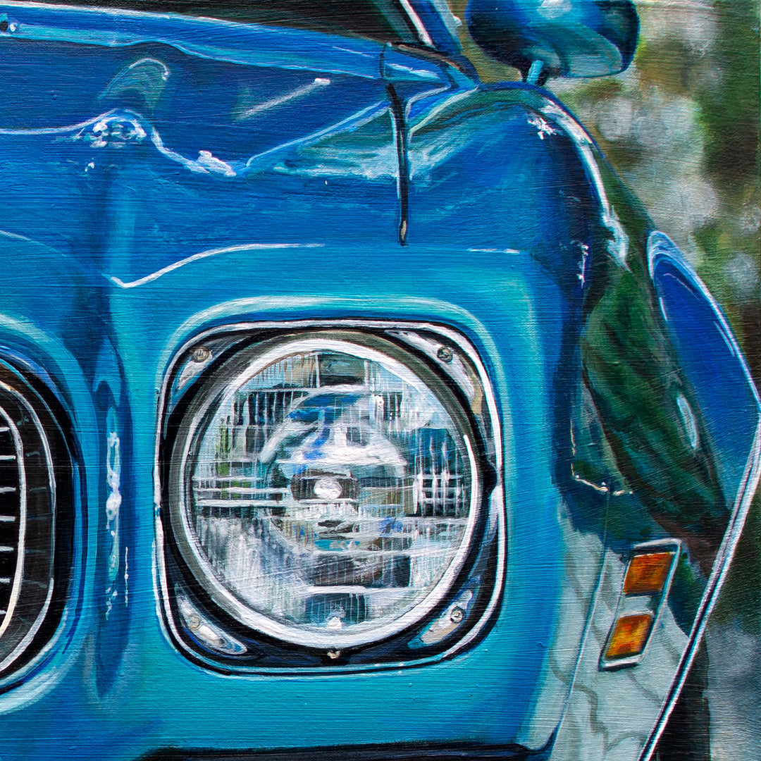 Close-up of the front left headlight and blue fender of a 1972 Pontiac Firebird Formula 400 M22. Artwork by Shan Fannin, 28 x 40", offered as a limited edition giclée print.