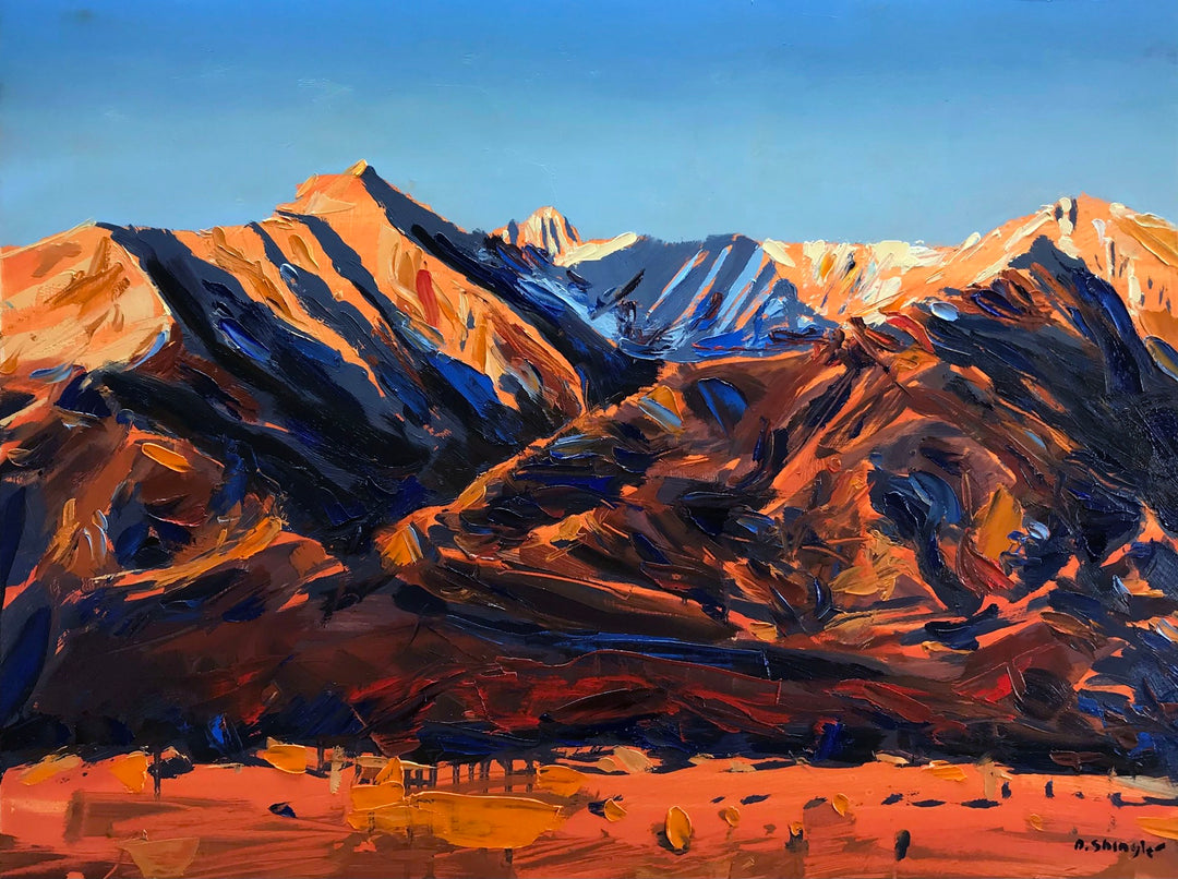 An oil on wood painting of the David Shingler - "Sangre De Cristo Sunrise" in Colorado. The artwork beautifully captures a majestic mountain range against a backdrop of a vibrant blue sky.