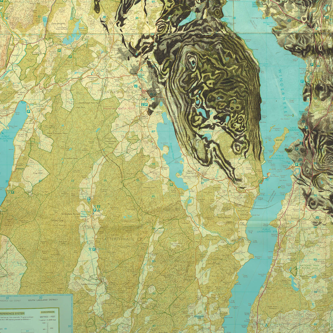 An Ed Fairburn | "Windermere" map of a lake with a mountain in the background.